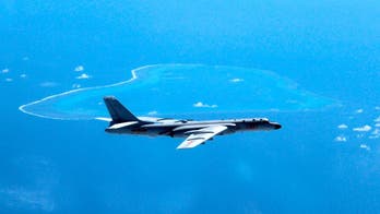 China tamps down South China Sea talk at summits