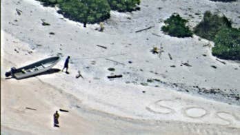 'SOS' in sand leads to rescue of 2 people stranded on island