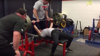 Watch this woman bench press 325 pounds in front of an entire college football team