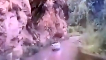 Car crushed by falling boulder in shocking video