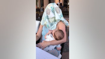 Breastfeeding mom told to cover up, instead puts cloth over own face