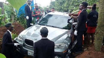 Photo of Nigerian man allegedly being buried in new BMW SUV goes viral