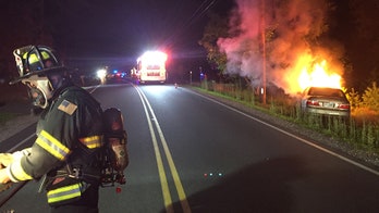 Police forced to drag man from his burning car
