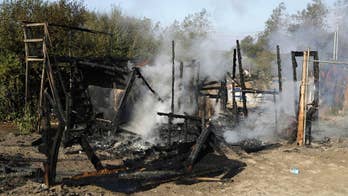 Crews start dismantling squalid French camp while refugees remain
