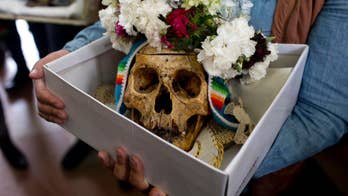 Bolivians carry human skulls asking for favors in festival