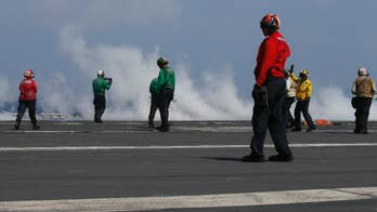 Top Philippine officials fly to US carrier in disputed sea