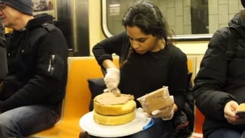 Woman ices and serves cake on NYC subway