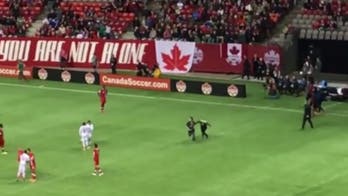 Pitch invader gets annihilated by security guard's crushing tackle