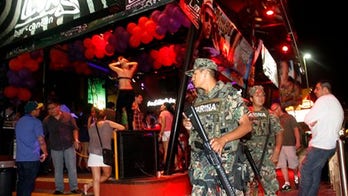 Youths flood Cancun under watch of marines, police