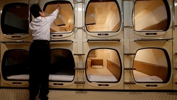 Squeezing into a capsule hotel room in Japan