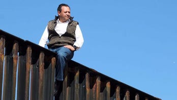 Mexican congressman climbs border fence to prove a point