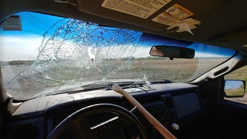 Ax smashes through windshield and strikes driver