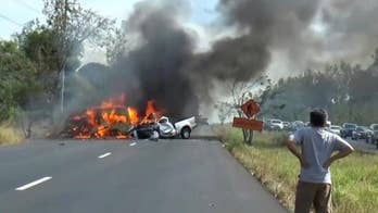 Van, truck collide, catch fire on Thai highway, killing 25