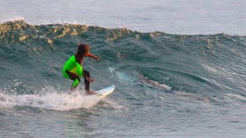 Young Aussie surfer photo bombed by shark that shared wave