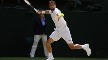 The Latest: Men's quarterfinals underway at Wimbledon