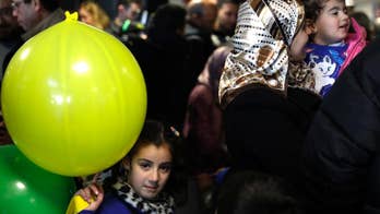 Italy welcomes 41 Syrian refugees, seeks bridges not walls