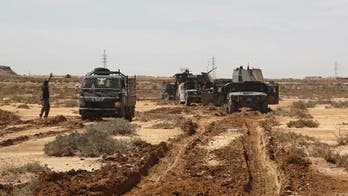 The Latest: Suicide attacks near Baghdad kill at least 10