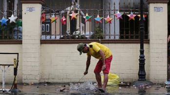 Philippines braces for Christmas storm, offers roasted pigs