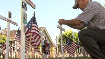 Homeowner fills yard with Memorial Day flags, crosses honoring fallen heroes