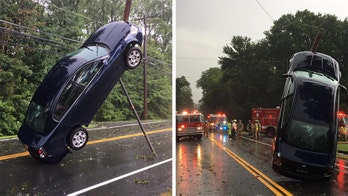 Car with family of three dangles off power line during Connecticut storm