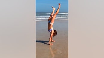 Watch Danica Patrick do an epic handstand walk down Daytona Beach