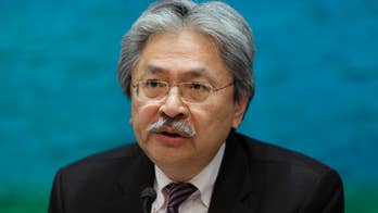 Hong Kong finance chief quits, leadership bid expected