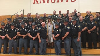 Indiana police officers support daughter of fallen trooper at graduation more than 10 years after his death