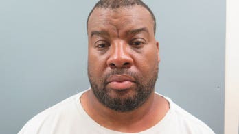 Ex-Army lieutenant colonel charged with collecting pay while in prison