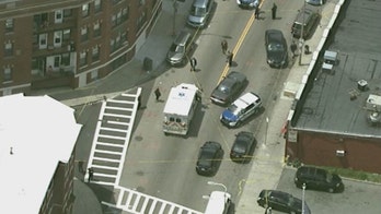 Boston authorities search for suspect in deadly shooting outside high school