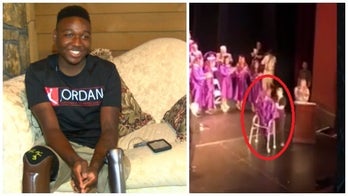 Double-amputee wows classmates after walking to accept high school diploma