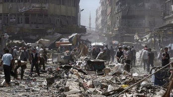 At least 80 killed in government airstrikes on Syria market, activists say