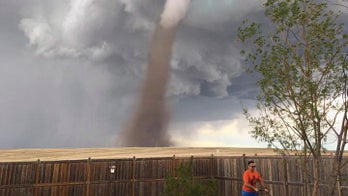 Tornado won't stop Canadian man from mowing his lawn, viral photo shows