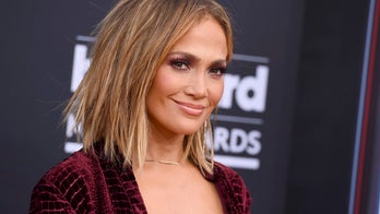 Jennifer Lopez poses half-nude in a sequined cape