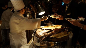 Explorers eat fried tarantulas at black-tie gala
