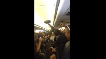 Passengers stuck on broken plane sing 'I Believe I Can Fly'
