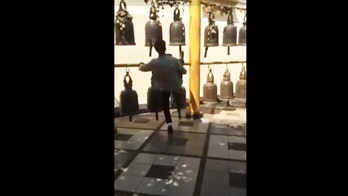 Thai police hunt for tourist caught kicking sacred temple bell