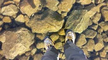 Stunning video captures hikers walking on crystal clear ice