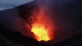 Daring wingsuit jumper flies over active volcano