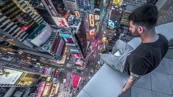 Photographer climbs to harrowing heights above Times Square