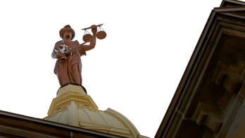 Remote-control helicopter stuck in arms of Lady Justice statue atop Ohio courthouse