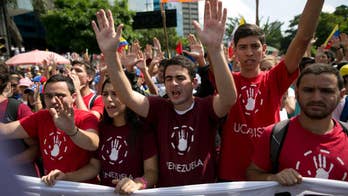 The Latest: Protesters gather in Venezuelan capital