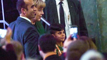 Germany's Merkel thanked by Afghan boy at party meeting