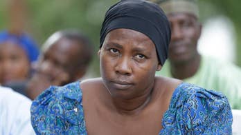 The Latest: 82 freed schoolgirls to meet Nigerian president