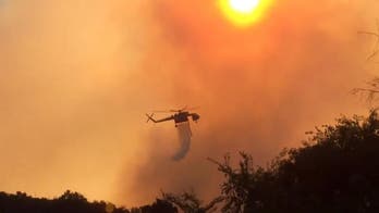 The Latest: Risk downgraded to oil facility near wildfire