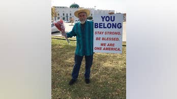 Dallas man holds sign of support outside Islamic center