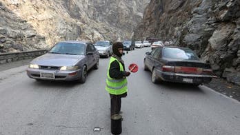 Afghan children direct traffic on mountain pass for $4 a day
