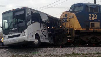 The Latest: Investigators looking into bus-train crash