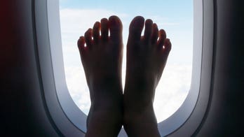 Flight passenger sleeping with bare feet on windows caught on video