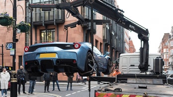 Ferrari flies through the air as London police seize it with crane