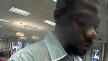 Suspect accused of burglarizing home before robbing bank in stolen shirt